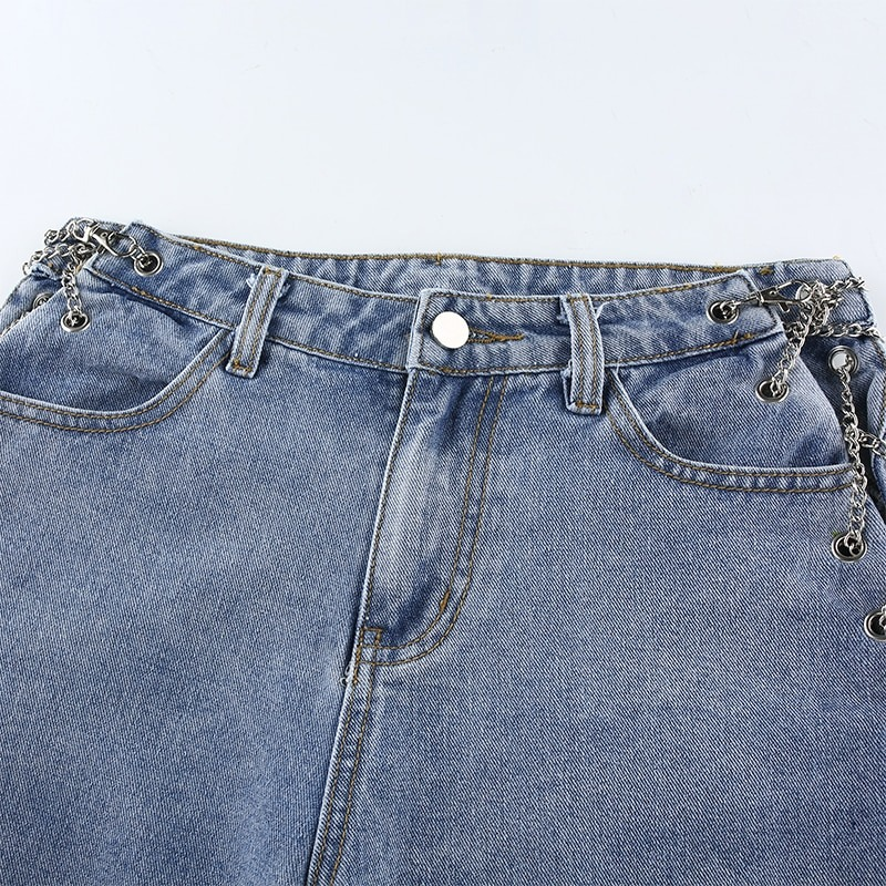 Close-up of high waist woman's jeans with chains, featuring stylish buttons and a casual straight cut design.