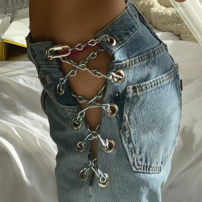 High waist women's jeans with chain detailing, showcasing stylish lacing and casual denim fashion.