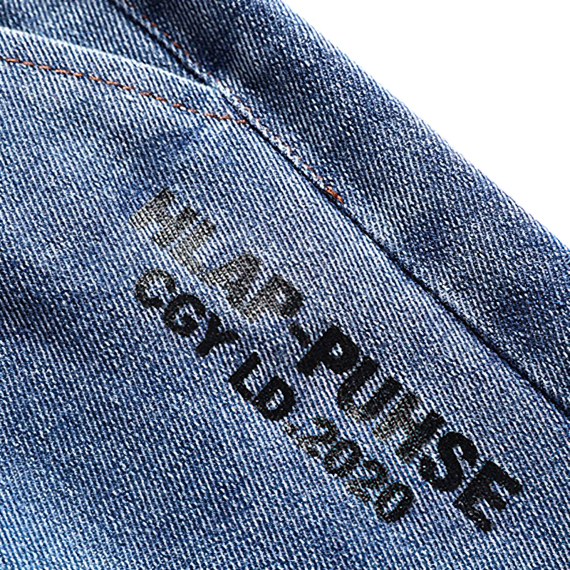 Close-up of cool loose denim shorts label featuring stylish text and stitching details.