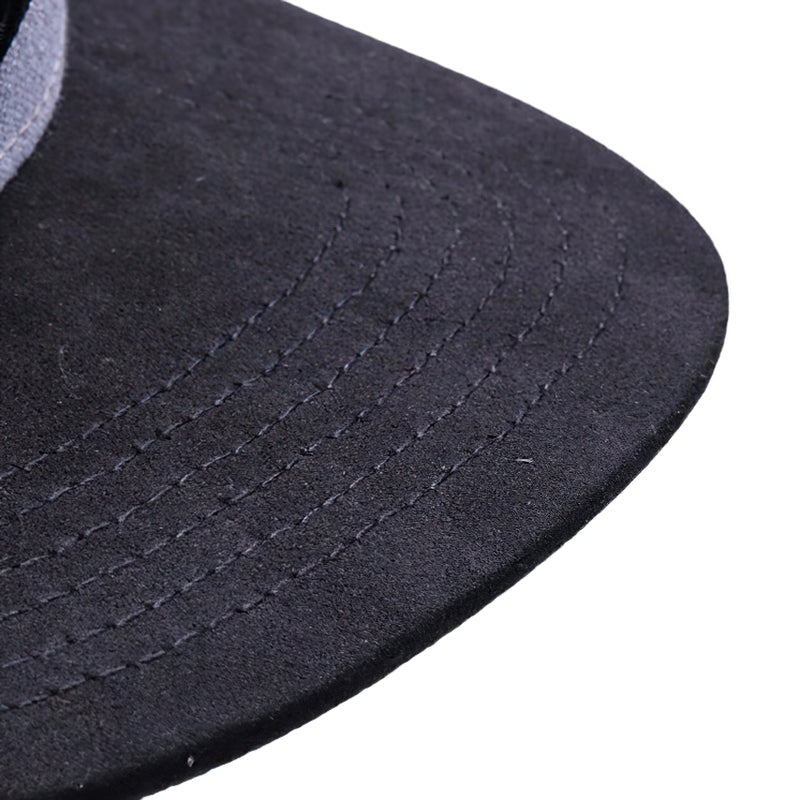 Close-up view of the stylish black brim of a cool men's streetwear cap with detailed stitching.