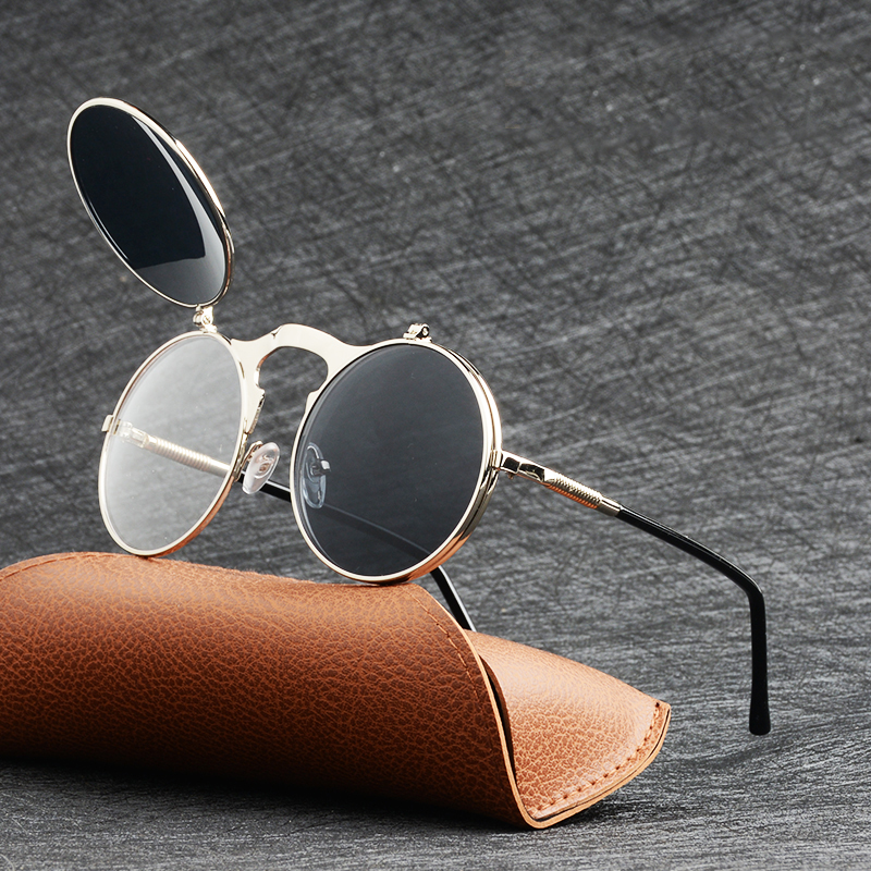 Cool metal round sunglasses with flip-up lenses on a brown case, stylish unisex eyewear for UV protection.