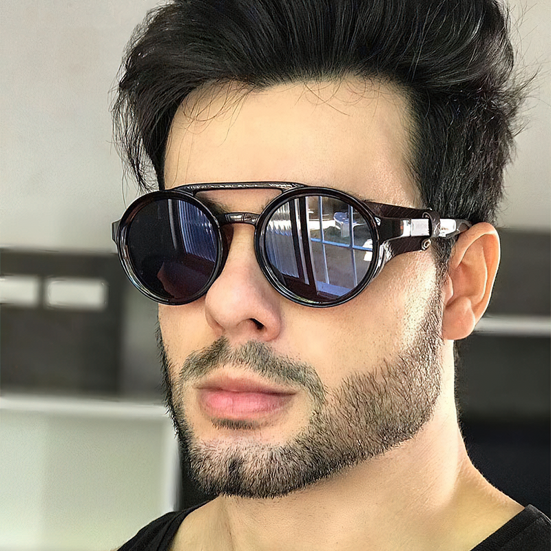 Stylish man wearing cool metal round sunglasses with reflective lenses, perfect for UV protection and retro fashion.