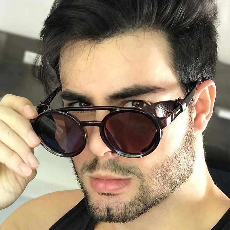 Man wearing cool metal round sunglasses, showcasing retro style and UV protection eyewear.