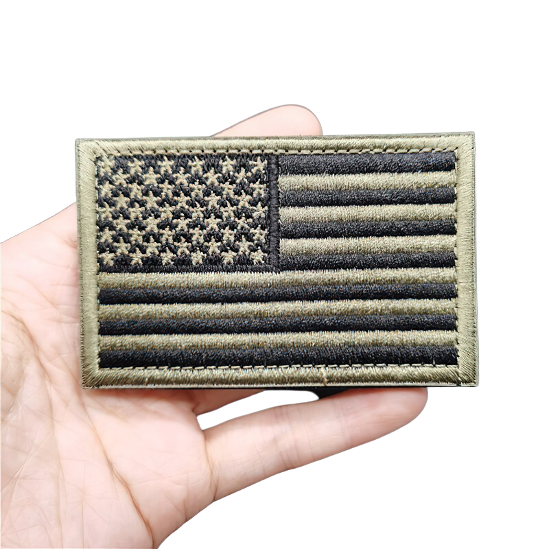 Unisex vintage military patch featuring an embroidered American flag with black and olive colors.