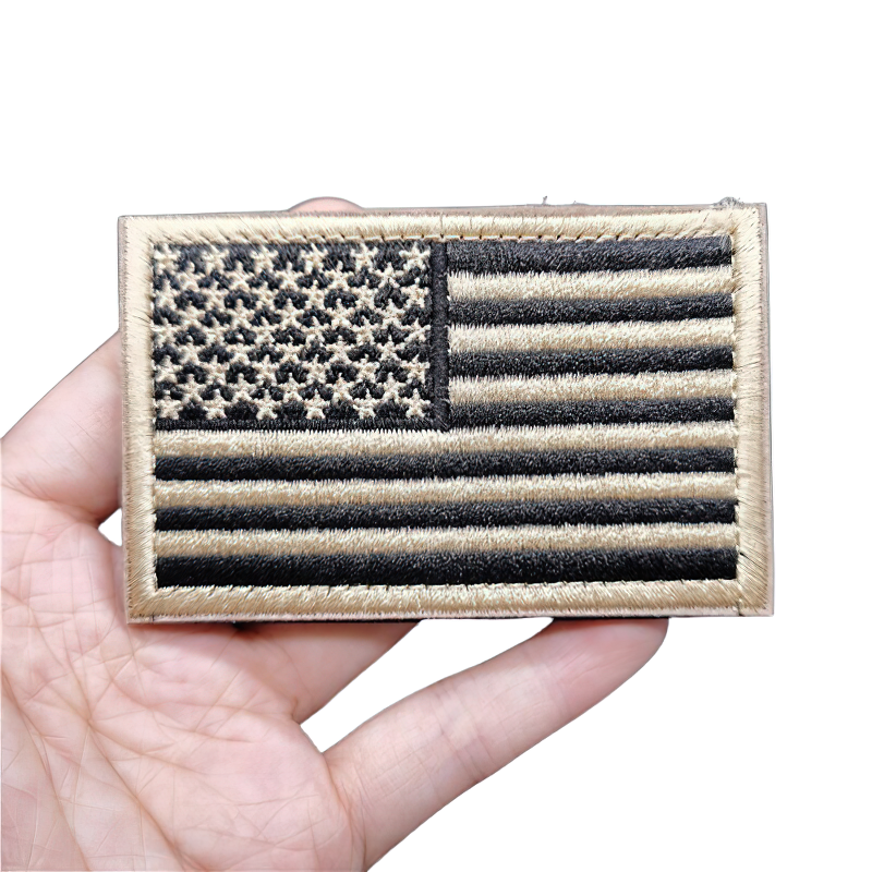 Unisex vintage military patch featuring an embroidered American flag in black and gold.