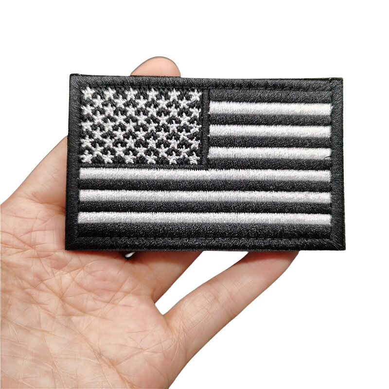 Unisex military patch featuring a black and white American flag design, perfect for vintage style clothing.