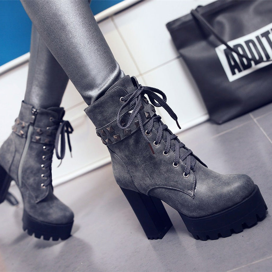 Cool motorcycle women's high heel winter boots with studs and laces, perfect for a daring biker look.