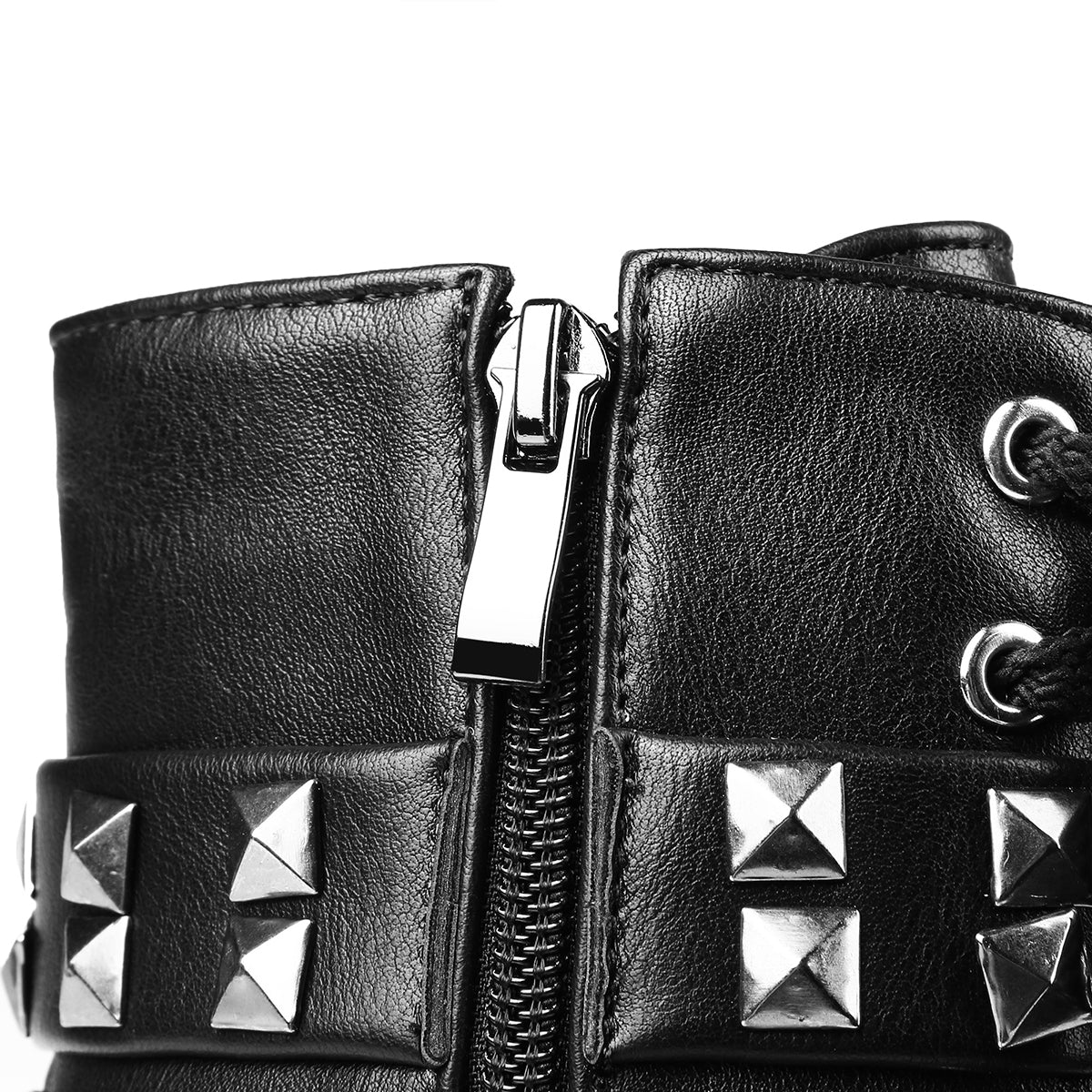 Close-up of stylish women's motorcycle boots with rivets, laces, and a shiny zipper, exuding a bold rock vibe.