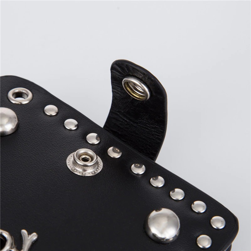 Close-up of rivets and snap detail on black punk style wallet with chain.