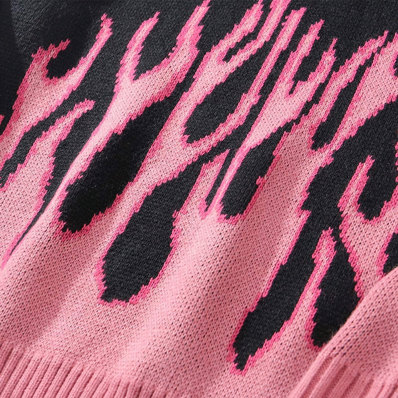 Close-up of a cool retro sweater featuring a pink flame pattern on a black background, perfect for casual style.