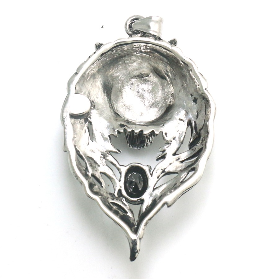 Intricate cool stainless steel wolf's head pendant featuring a black crystal, perfect for punk and gothic jewelry lovers.