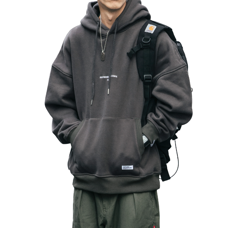 Stylish men's thin fleece hoodie in dark gray worn casually with a backpack, showcasing streetwear fashion.