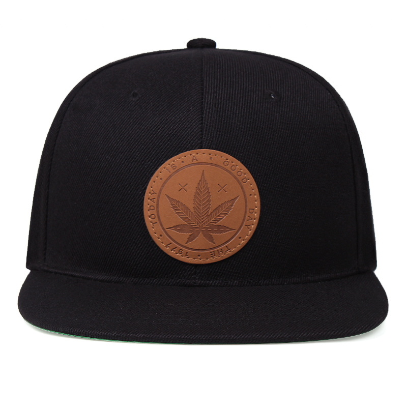 Cool black snapback cap featuring a stylish leather maple leaf patch, perfect for any casual outfit.
