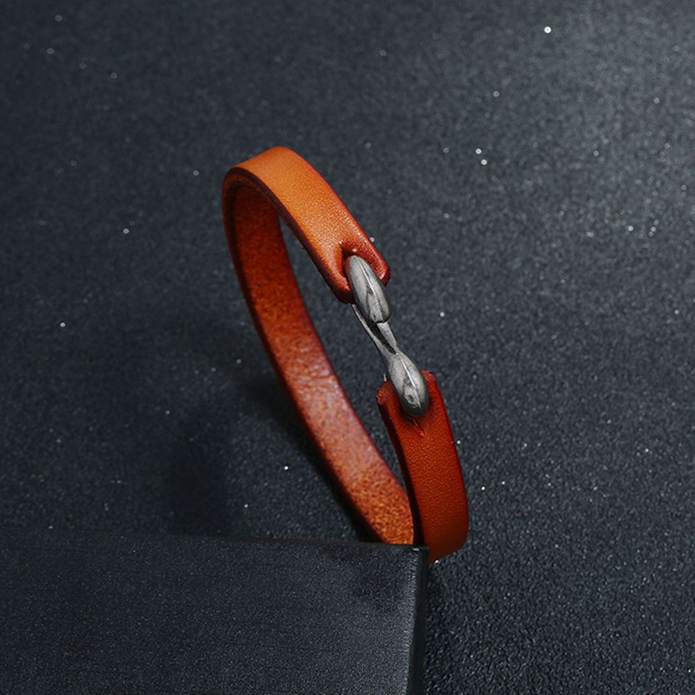 Cool unisex genuine leather narrow bracelet in orange with a stylish clasp, perfect for casual rock-inspired outfits.