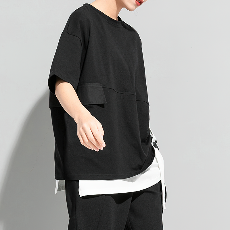 Cool women's black pleated t-shirt with contrasting white elements and short sleeves for versatile fashion styling.