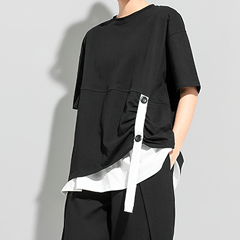 Cool women's black pleated T-shirt with buttons and contrasting white elements for alternative fashion.