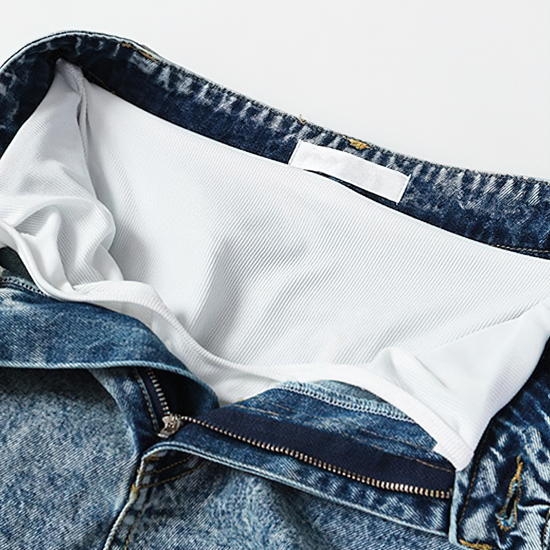 Interior view of trendy women's denim mini shorts with soft lining and ruffle details, perfect for summer style.