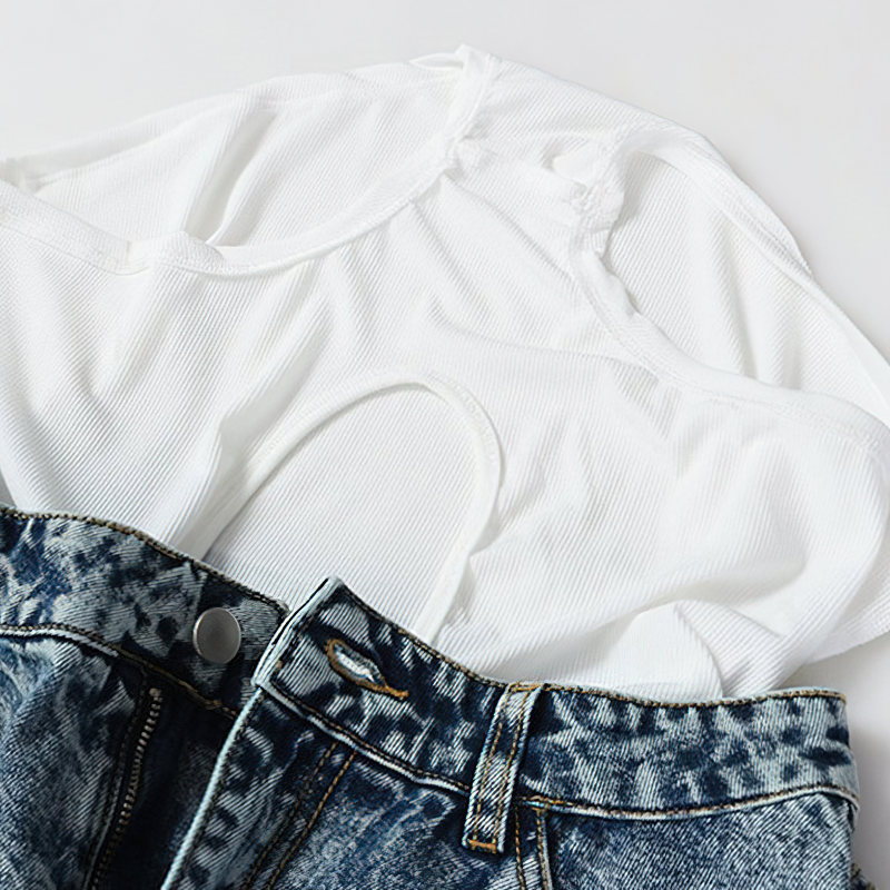 White tank top and denim mini shorts showcasing trendy summer fashion. Perfect for a playful outfit!