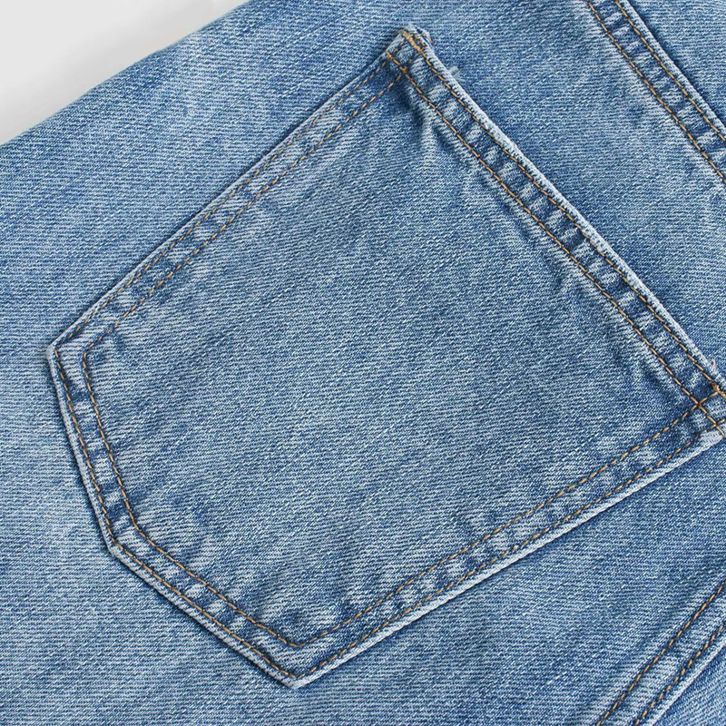 Close-up of a back pocket on cool women's high waist overlength wide leg denim pants.