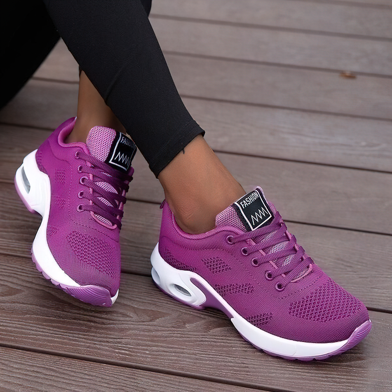 Cool women's lace-up sneakers in vibrant purple with breathable mesh design, perfect for stylish, trendy looks.