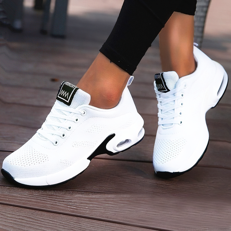 Cool women's white lace-up sneakers with breathable mesh design, ideal for stylish and trendy outfits.