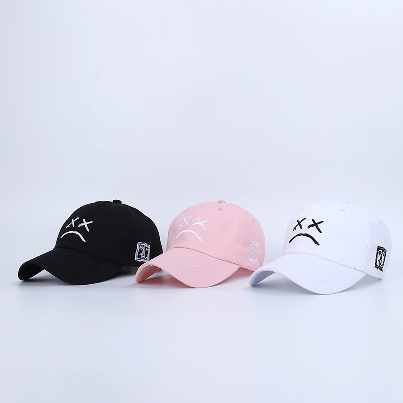 Cotton baseball caps in black, pink, and white featuring crying face print, perfect for casual summer style.
