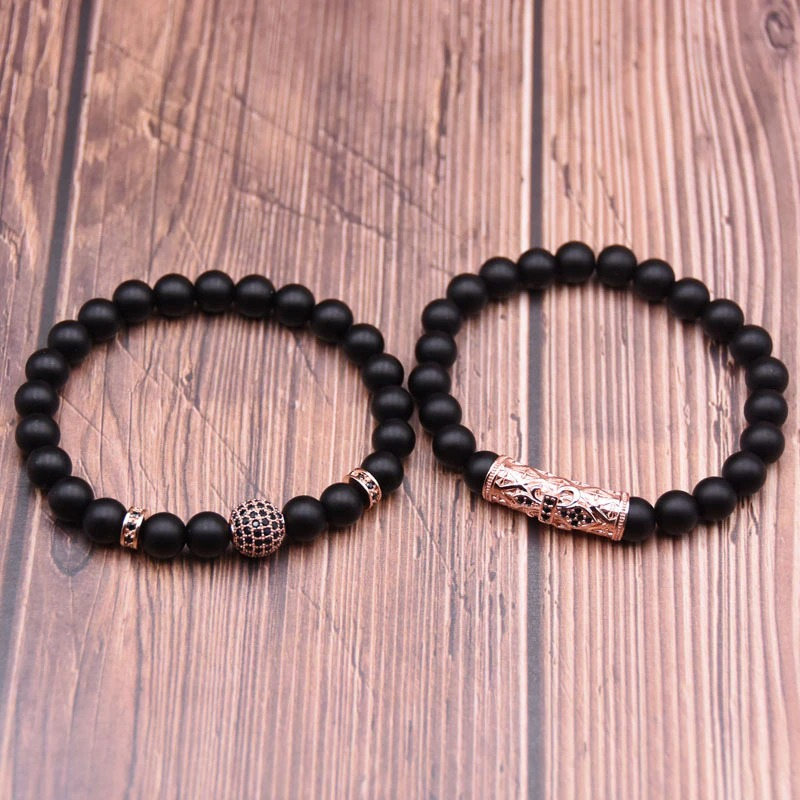 Couple round punk bracelets in black beads, featuring decorative round and cylindrical accents, perfect for unisex styling.