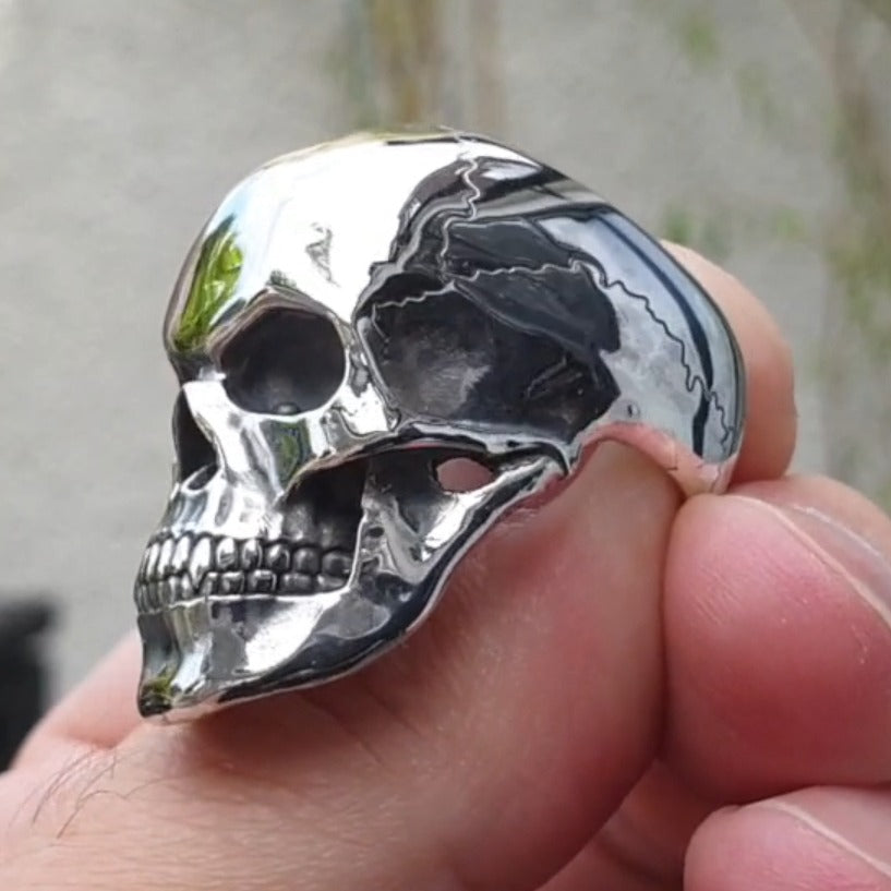 Stylish cracked skull head ring, crafted in metal, perfect for rock and goth style fashion for men and women.