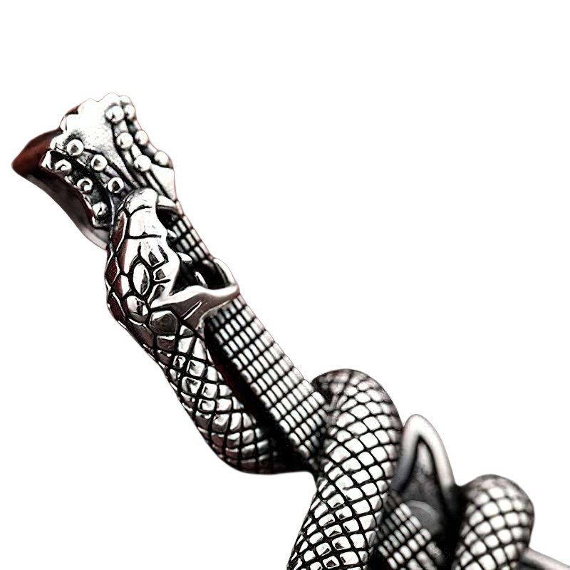 Close-up of a detailed snake design on a silver guitar-shaped pendant, showcasing rock style elegance.