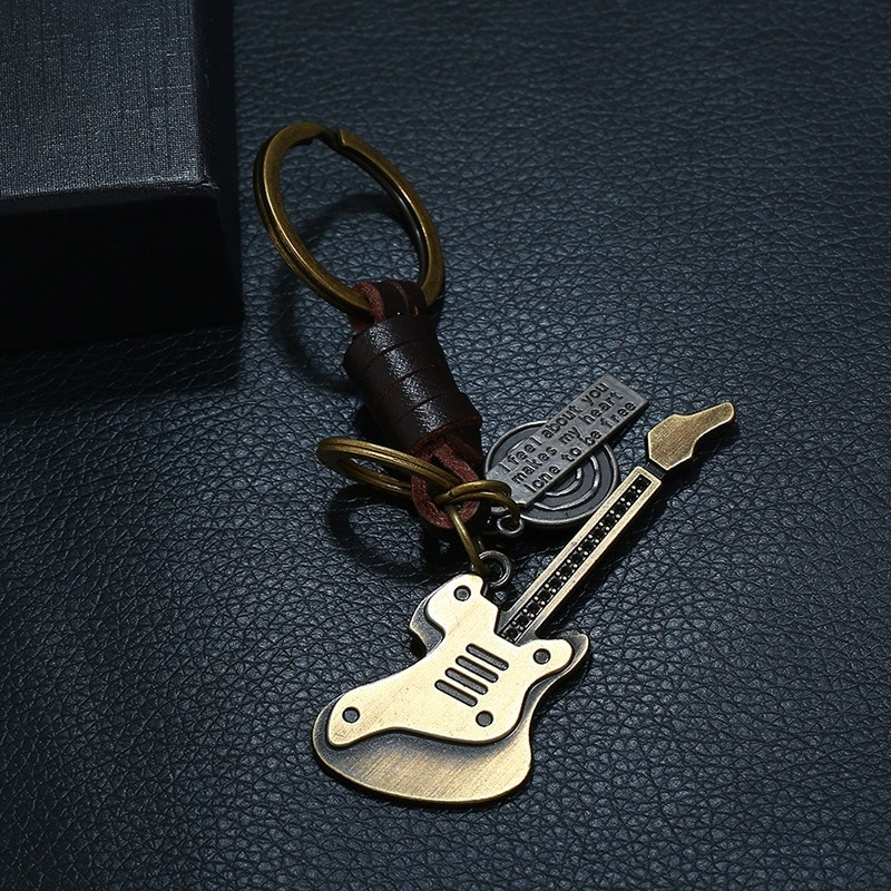 Genuine leather and alloy keychain in guitar shape, vintage punk style accessory for music lovers.