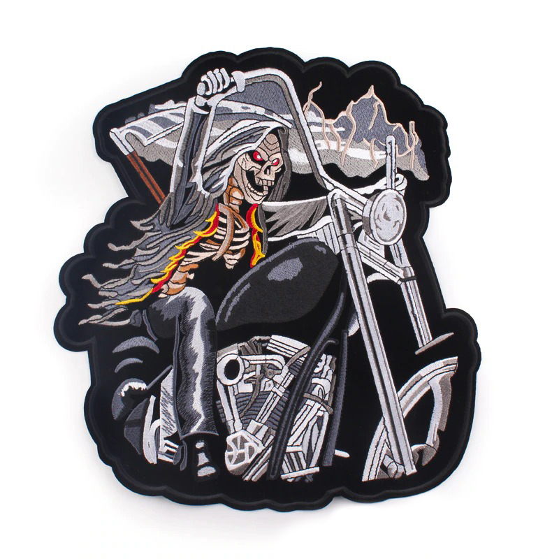 Creepy skull riding motorcycle iron-on patch for jackets, large embroidered biker patch for stylish outerwear.