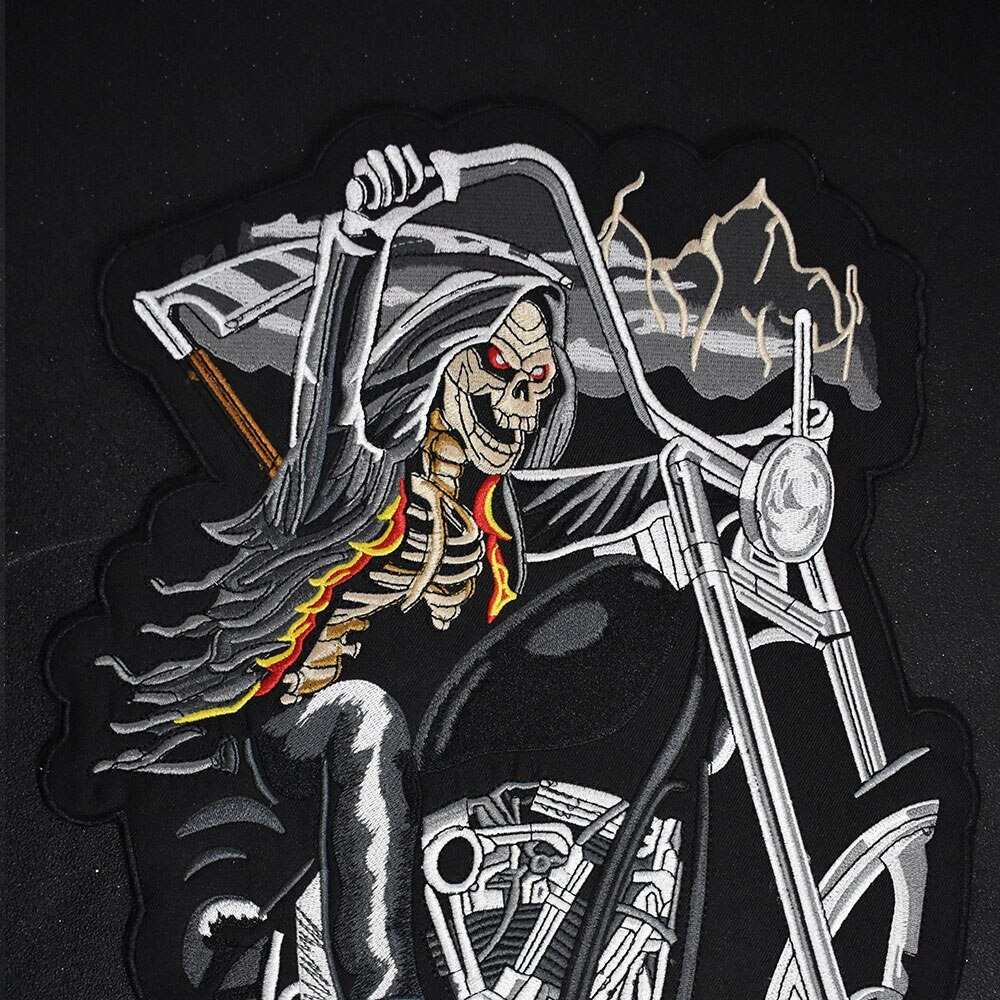 Large embroidered skull riding a motorcycle iron-on patch for jackets and clothes.