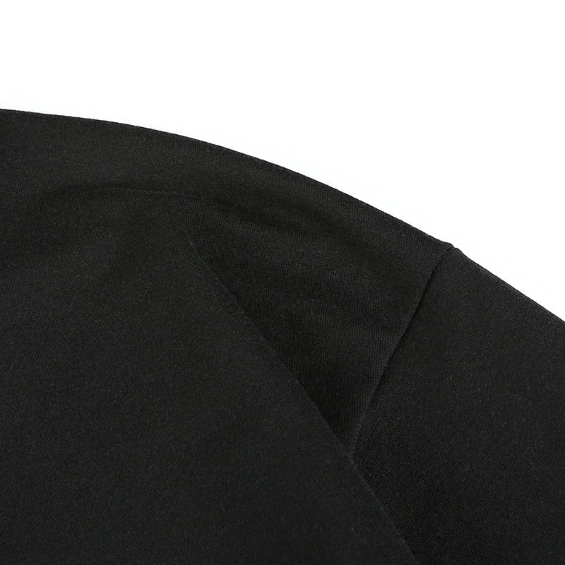 Close-up of the black fabric texture of a cropped women chain cold shoulder top in gothic style.
