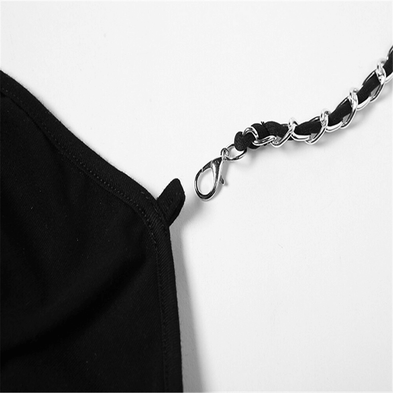 Close-up of a black mini dress featuring a stylish chain belt detail, highlighting chic fashion design elements.