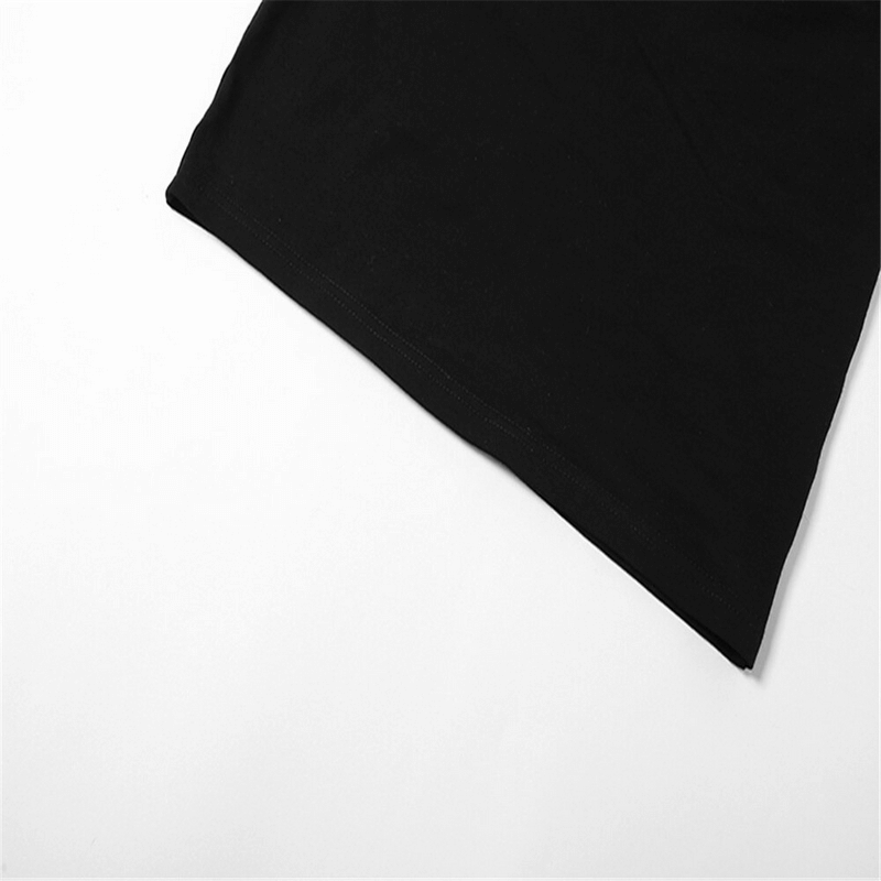 Close up of the hem of a black cut out bodycon mini dress highlighting its sleek fabric and stylish design.