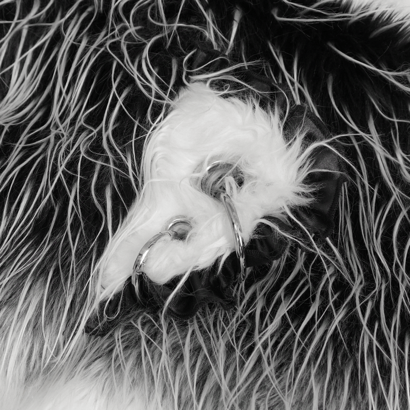 Close-up of grey faux fur detailing with rivets on a cute animal ear flap hat.
