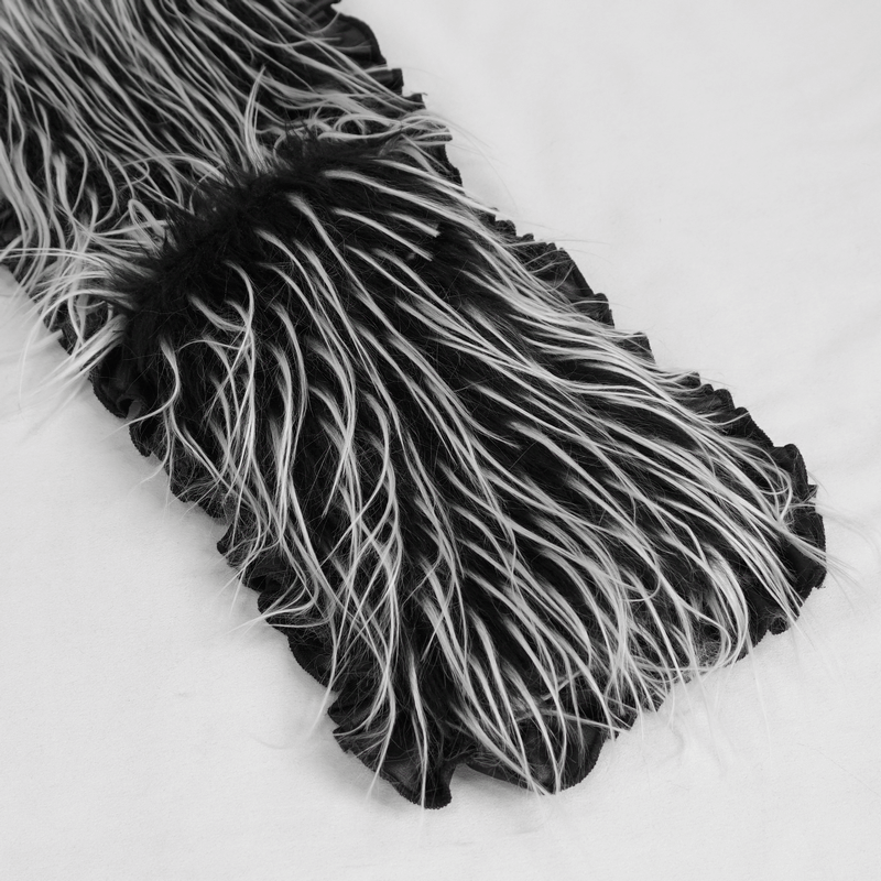 Close-up of black and white faux fur fabric with long, soft strands, perfect for stylish accessories or warm garments.