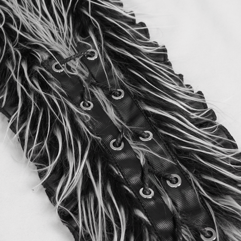 Close-up of a black and grey faux fur textile with rivets, showcasing detailed texture and unique design.