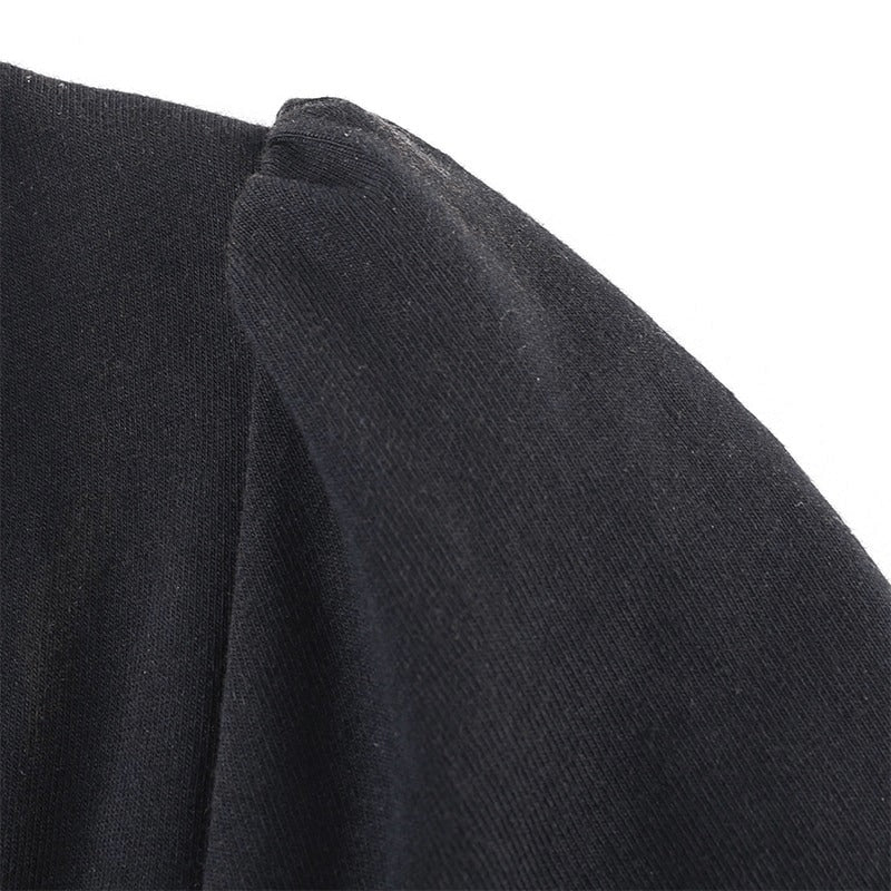 Close-up of the sleeve detail on an elegant black dress, showcasing soft fabric and gothic style.