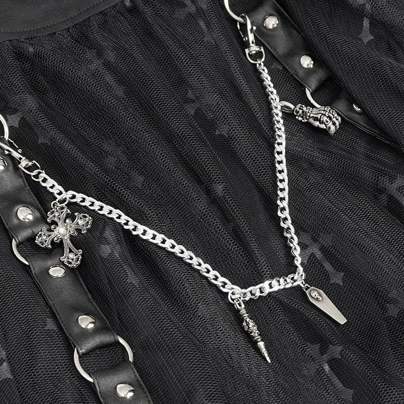 Close-up of a black skirt with waist straps and a detachable metal chain featuring decorative charms.