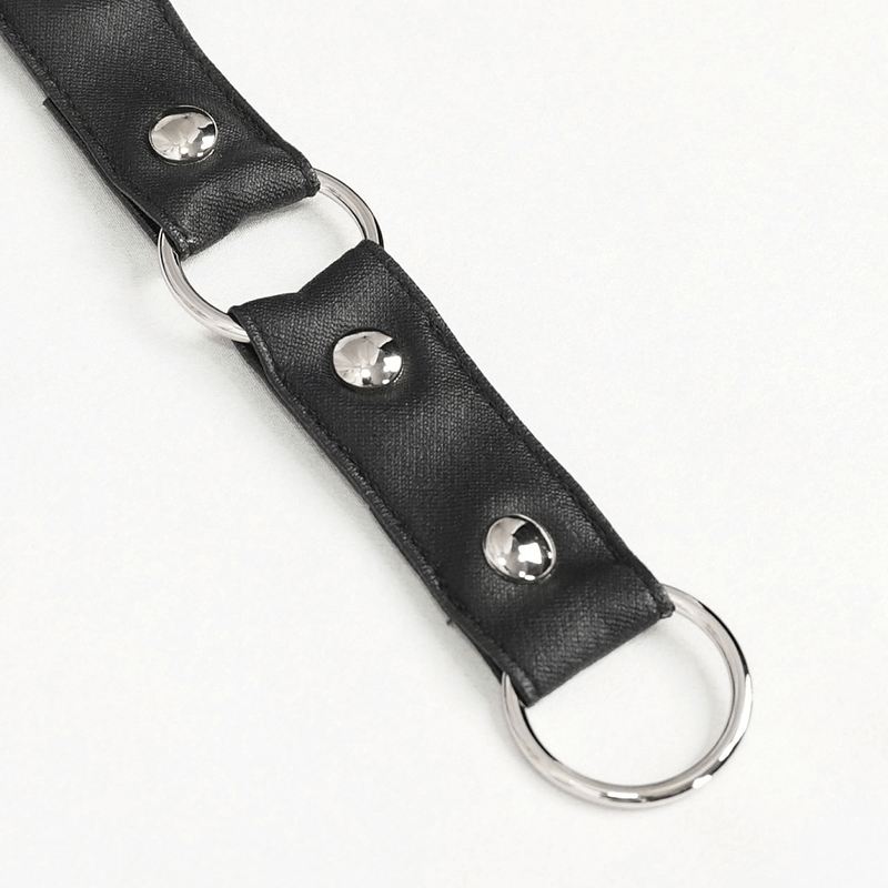 Close-up of a black skirt strap with silver studs and metal rings, perfect for a punk fashion look.