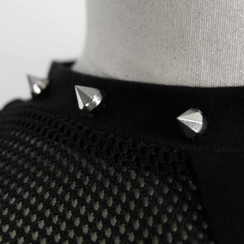 Close-up of black mesh top with silver spikes, showcasing gothic fashion details and elegant grunge style.