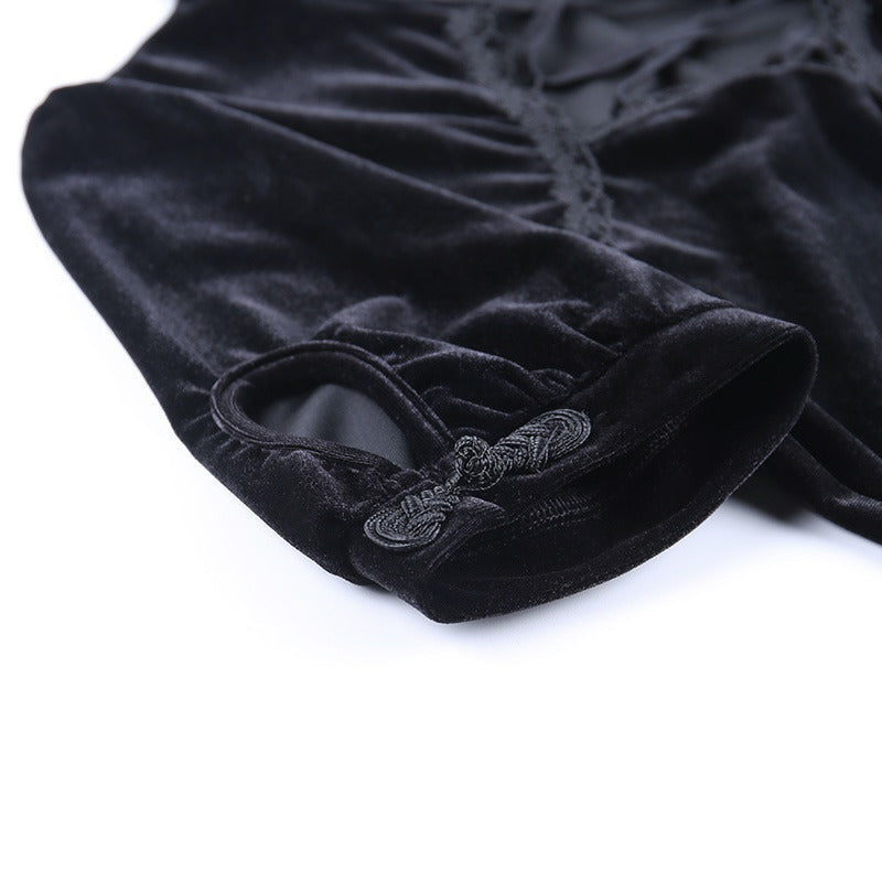 Close-up of the sleeve detail of a black vintage gothic dress featuring lace-up accents and soft velvet fabric.