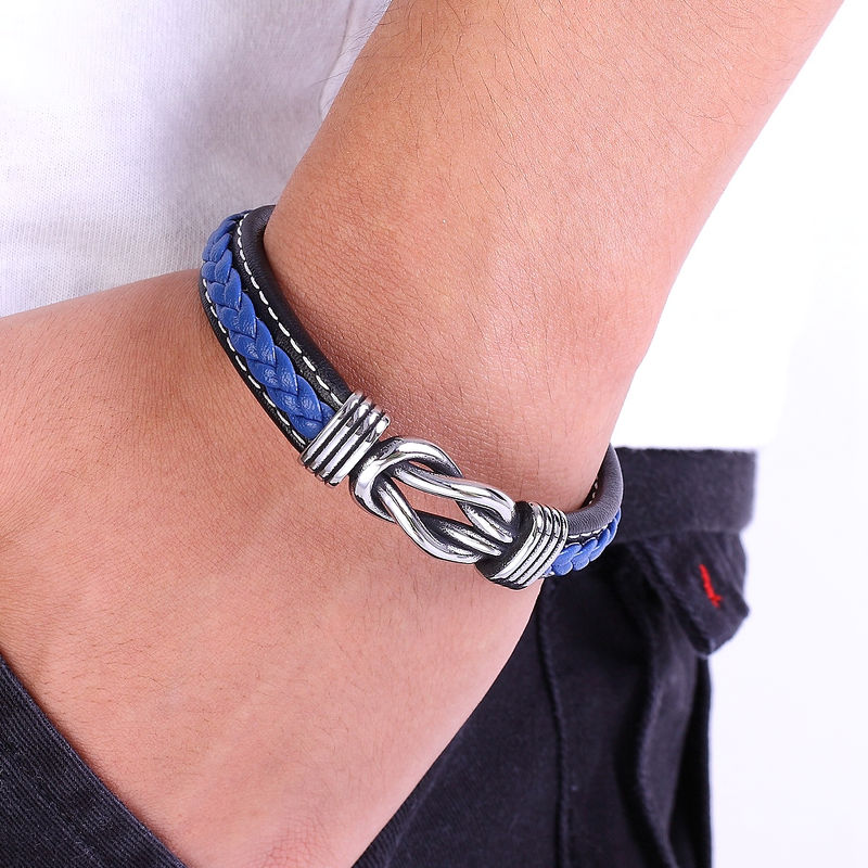 Trendy men's leather bracelet with blue braided design and stainless steel clasp, showcasing an irregular graphic style.