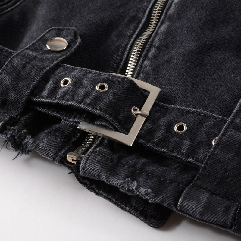 Close-up of a black denim punk jacket featuring a side zip and stylish hip belt with silver buckle.