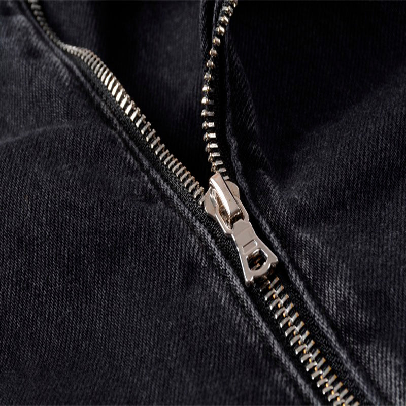 Close-up of a stylish zipper on a men's punk denim jacket, highlighting trendy design and details.