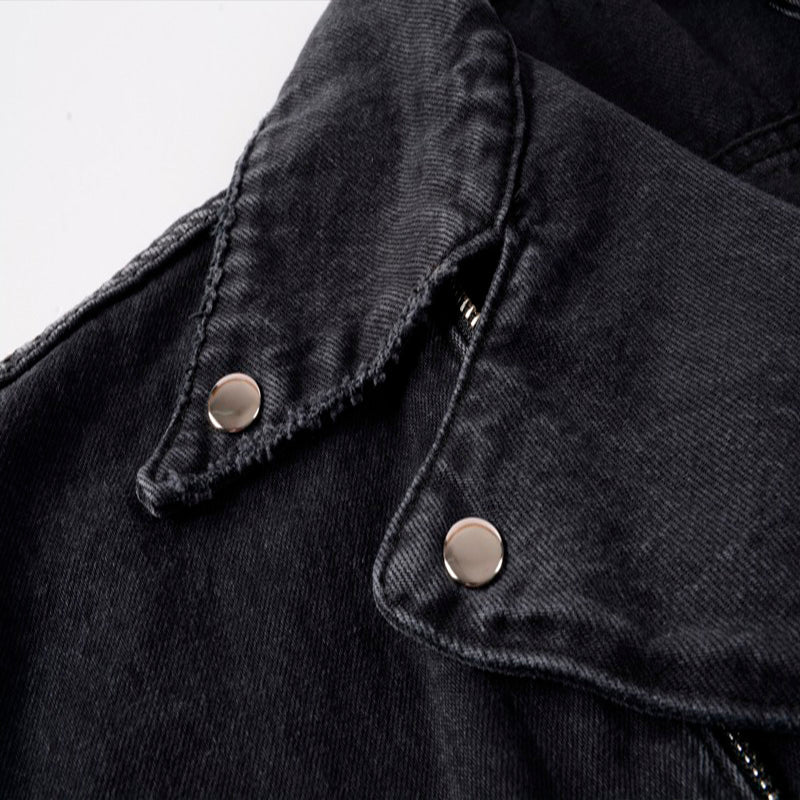 Close-up of the black denim punk jacket showing metal rivets and stylish collar for streetwear fashion.