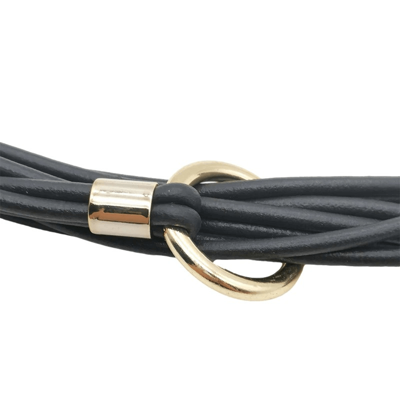 Close-up of a designer handmade black rubber necklace with gold accents, perfect gothic accessory for women.