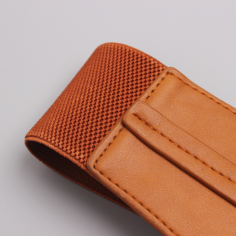 Close-up of a trendy orange PU leather wide belt for women, showcasing its textured design and comfortable fit.