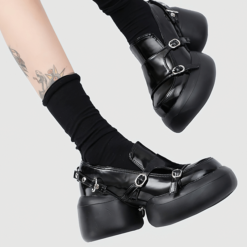 Trendy black patent leather loafers with buckles and chunky heels, perfect for punk style outfits.